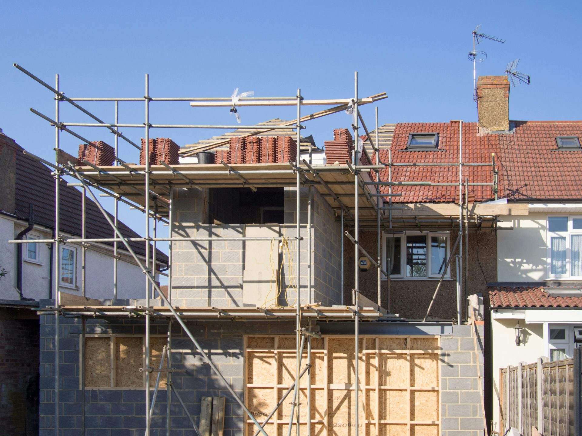 House extension under construction with scaffolding.