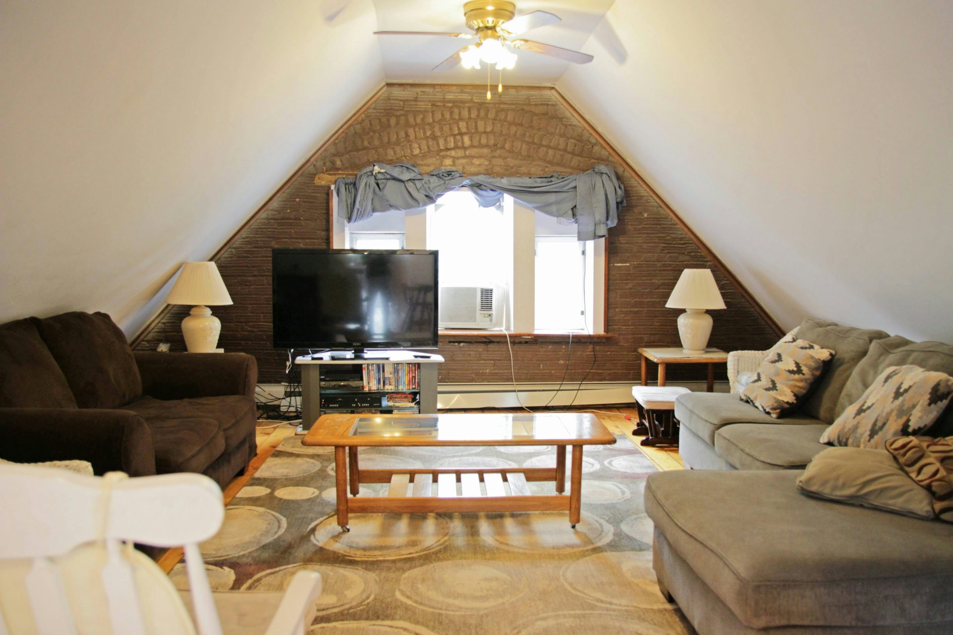 Cosy attic living room with comfortable seating.